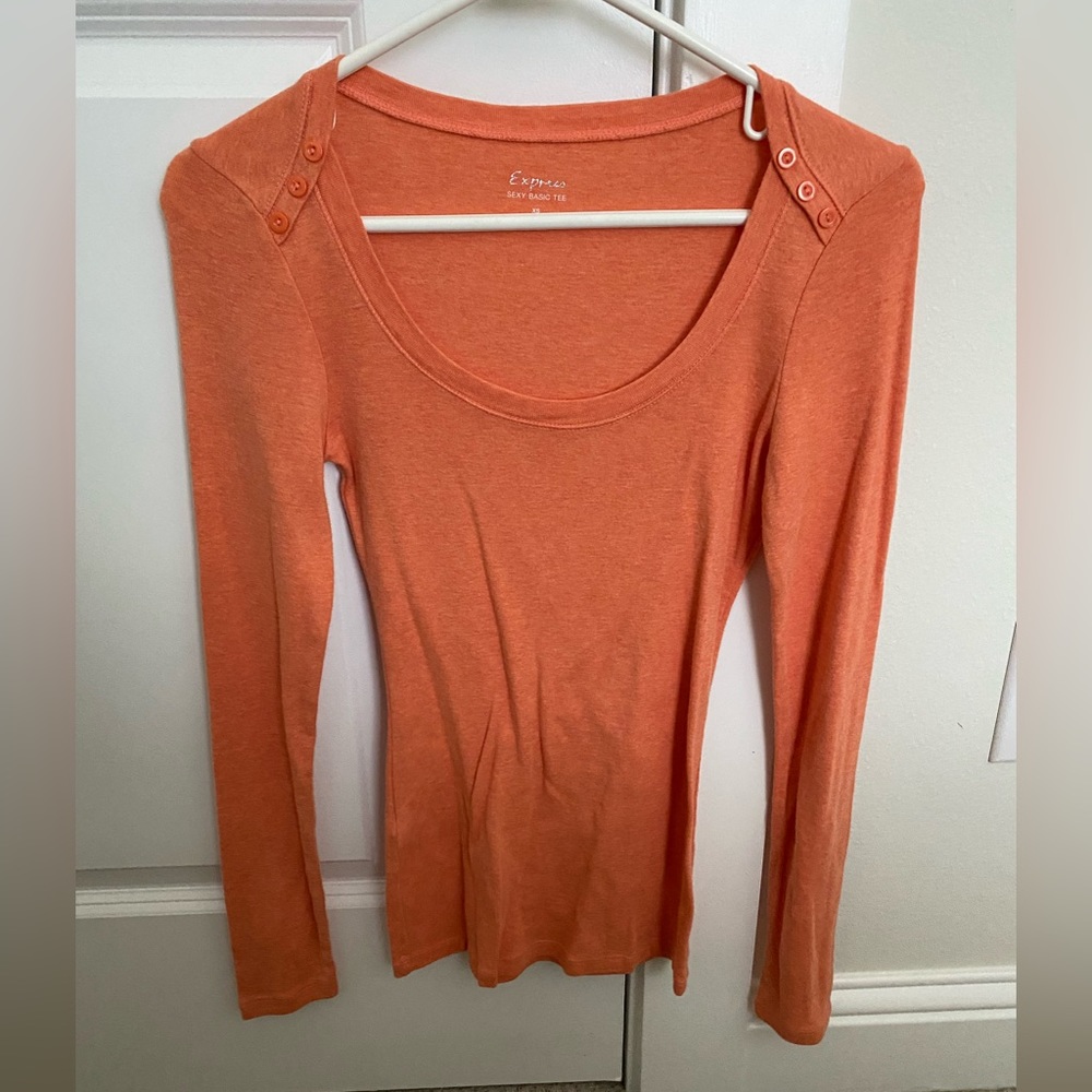 Orange long sleeve shirt with button detail at the neckline